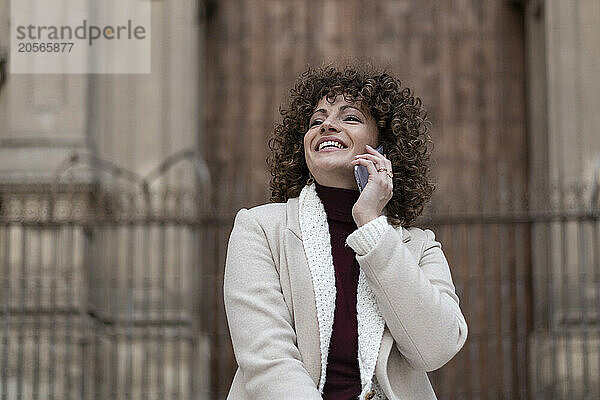 Happy woman talking on smart phone