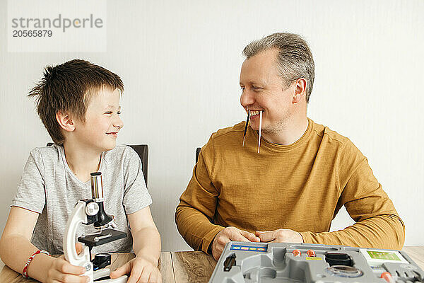 Happy father and son spending leisure time at home