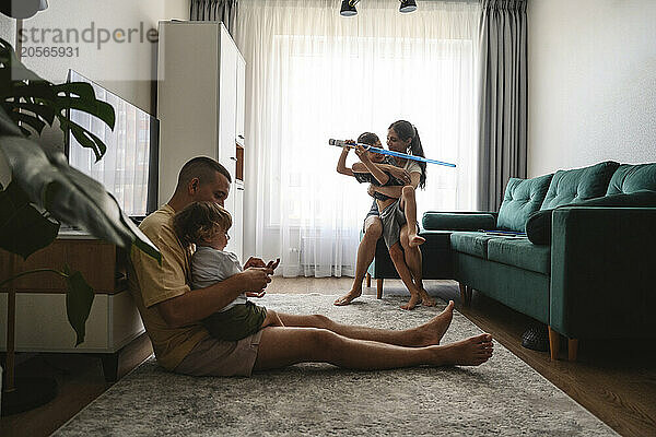 Mother and father playing with kids at home