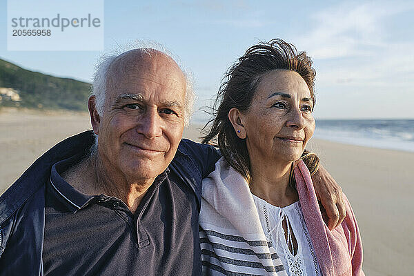 Smiling senior man and woman at beach