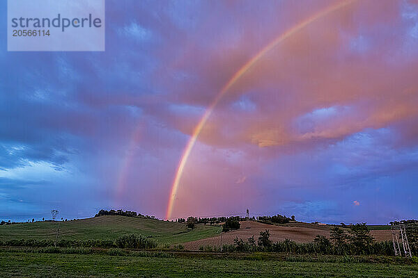 Rainbow at dusk under cloudy sky in Maremma  Tuscany  Italy