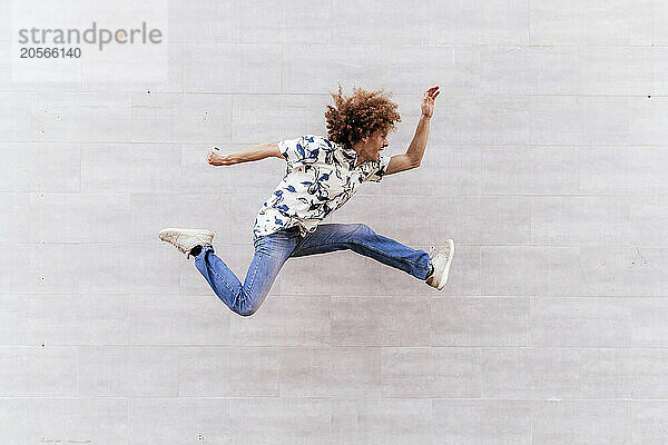 Man doing parkour in front of wall