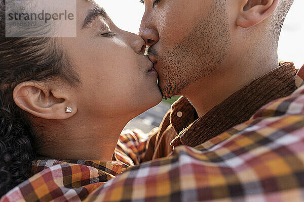 Affectionate couple kissing at park