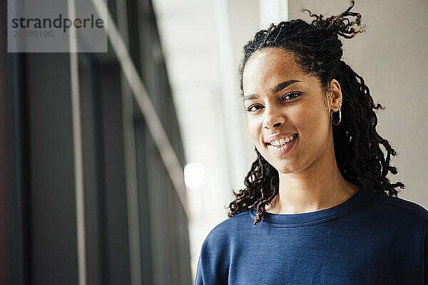 Smiling young beautiful businesswoman in office