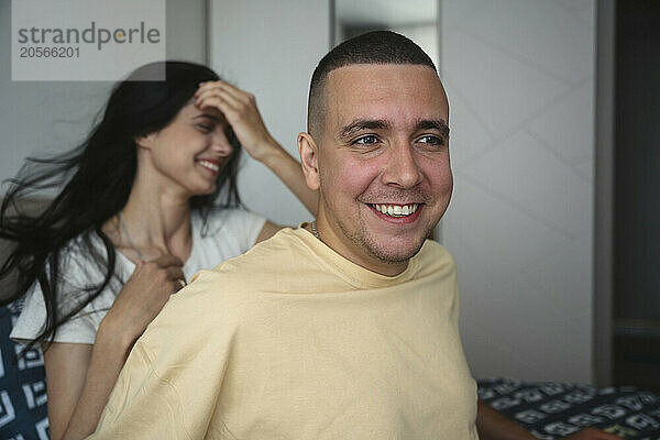 Happy man and woman spending leisure time at home