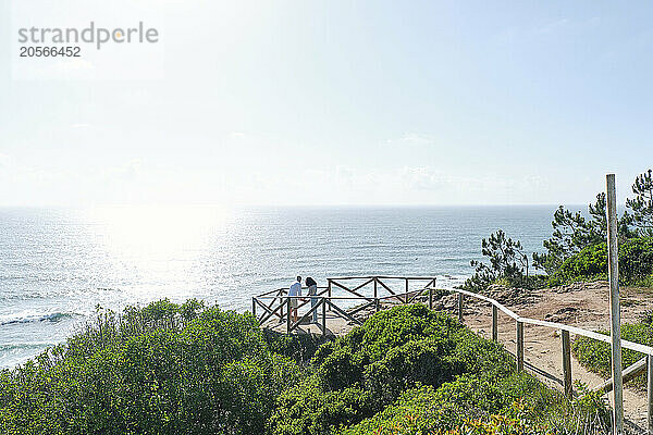 Boyfriend and girlfriend at observation point near sea