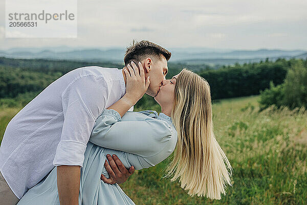 Romantic boyfriend and girlfriend kissing on mountain in Poland