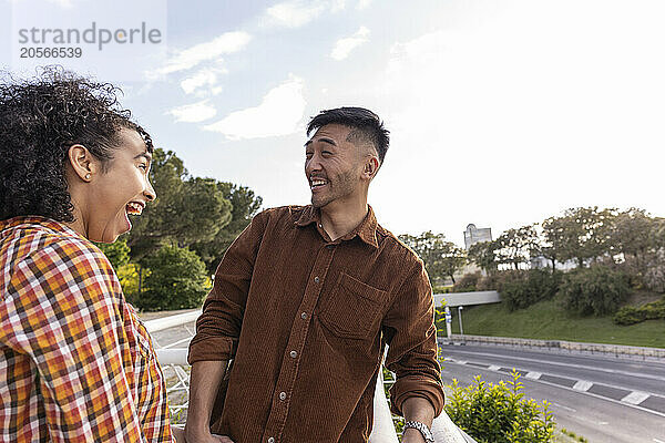 Cheerful multiracial couple spending leisure time at park