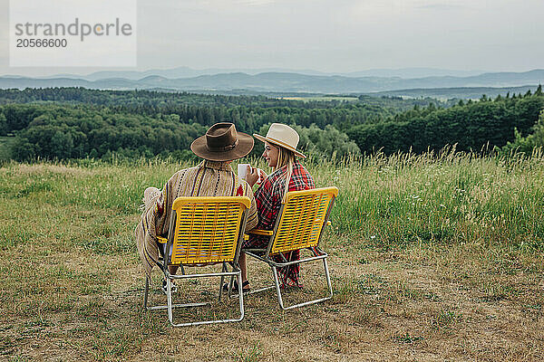 Young couple drinking tea and spending leisure time on mountain of Poland