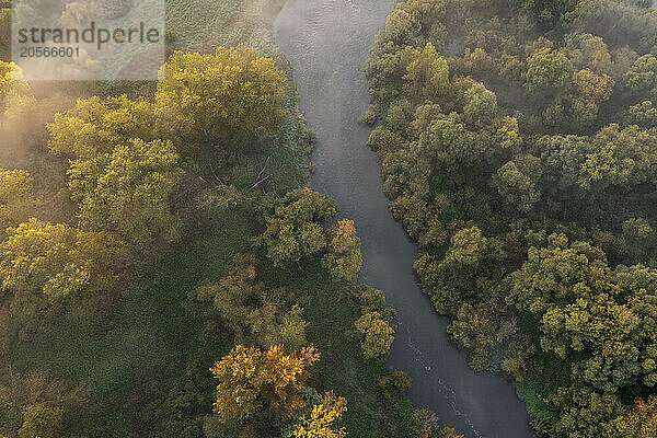 Germany  Bavaria  Aerial view of morning fog floating over river Main in autumn