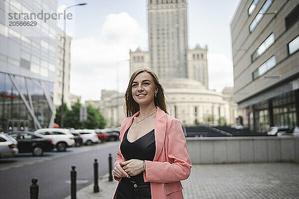 Happy young woman standing at street in Poland