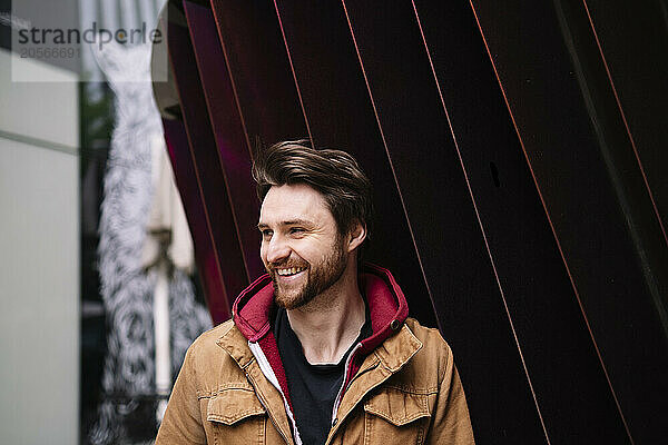 Handsome smiling man in brown jacket