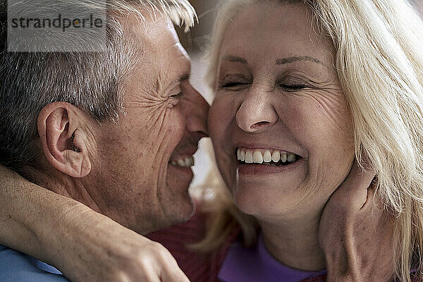 Cheerful loving retired man with blond senior woman