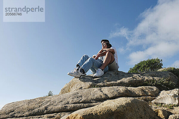 Boyfriend and girlfriend sitting together on rocks