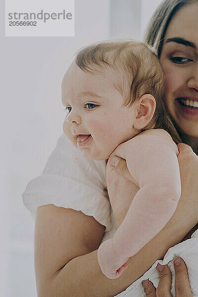 Cute baby boy with mother at home