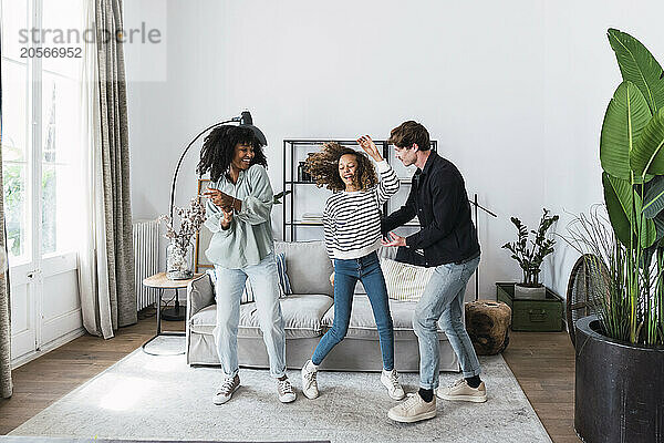 Happy family havin fun dancing together in the living room