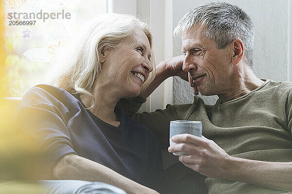 Happy senior couple sitting at home