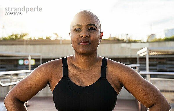 Bald muscular woman on sunny day