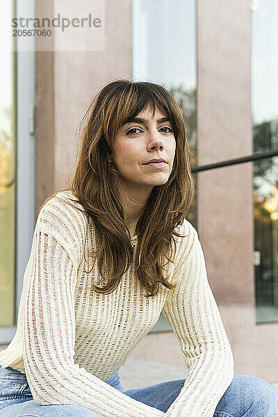 Confident woman with long brown hair