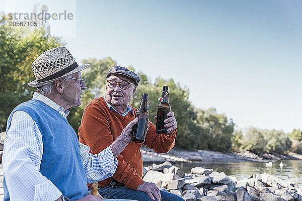 Friends enjoying drink at riverside