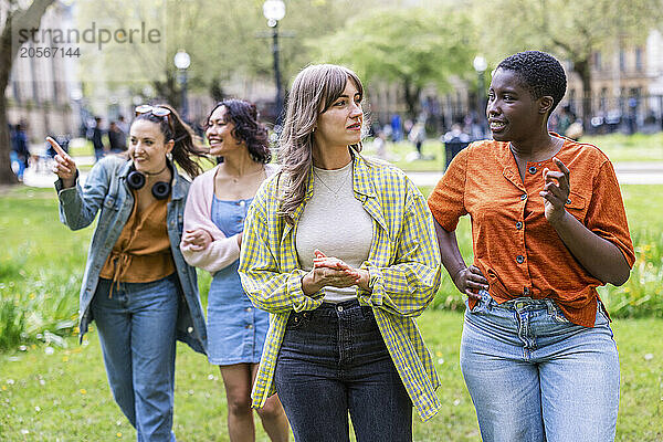 Women talking and walking together at park