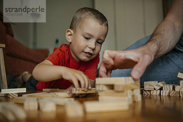 Father and son playing blocks at home