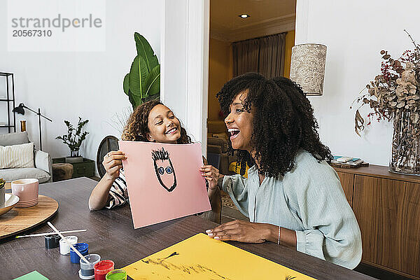 Daughter showing mother new painting