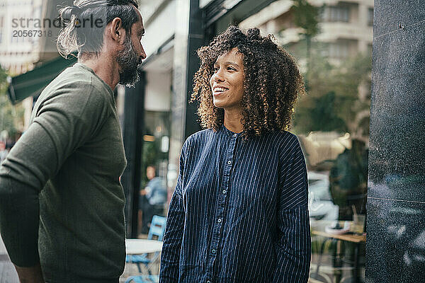 Coworkers having discussion in front of cafe