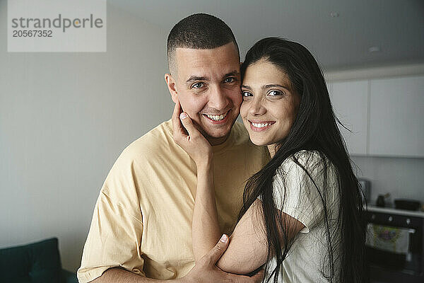 Smiling woman with long hair next to man at home