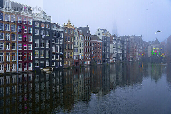 Dancing Houses near Amstel river at foggy day