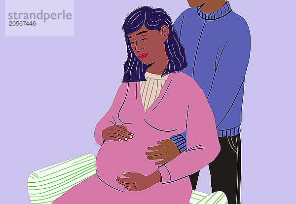 Man with pregnant woman touching belly on chair in front of blue background