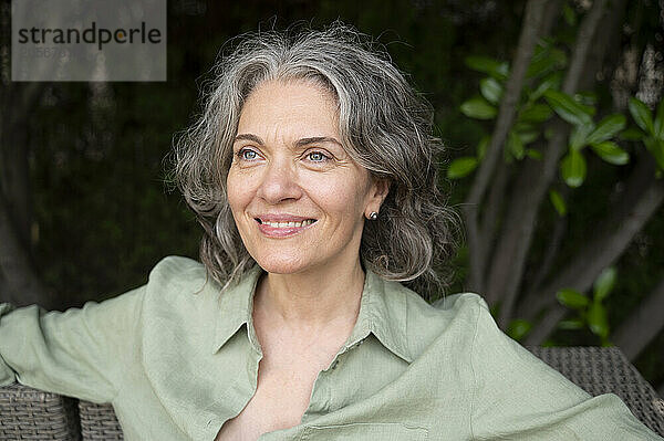 Beautiful happy gray hair woman relaxing on terrace