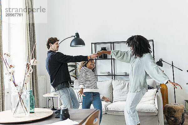 Happy family havin fun dancing together in the living room