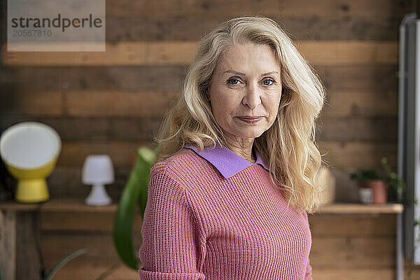 Senior blond woman wearing sweater at home