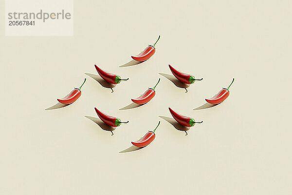 Red chili peppers over beige background