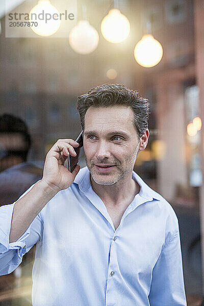 Mature handsome businessman talking on mobile phone