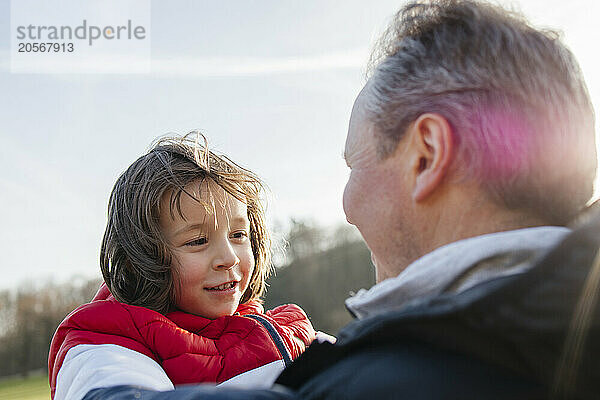 Boy with father at sunny day