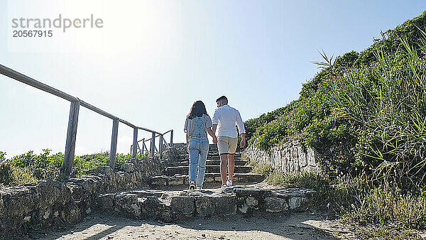 Boyfriend and girlfriend moving up on steps