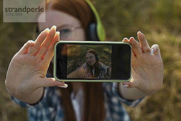 Teenage girl taking selfie through smart phone