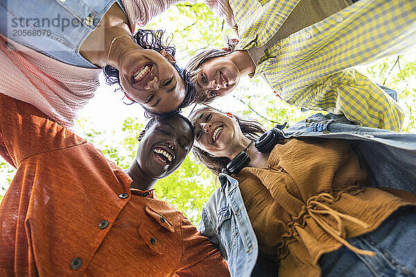 Happy women huddling together at park