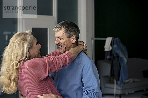 Happy retired senior couple enjoying leisure time with together at home