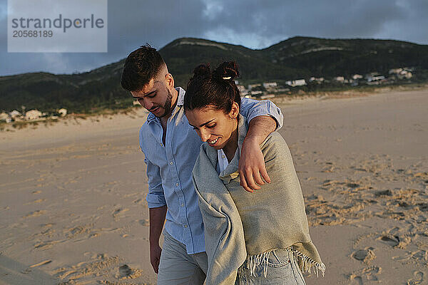 Young couple strolling at beach