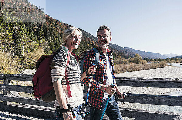 Happy couple with backpacks on weekend