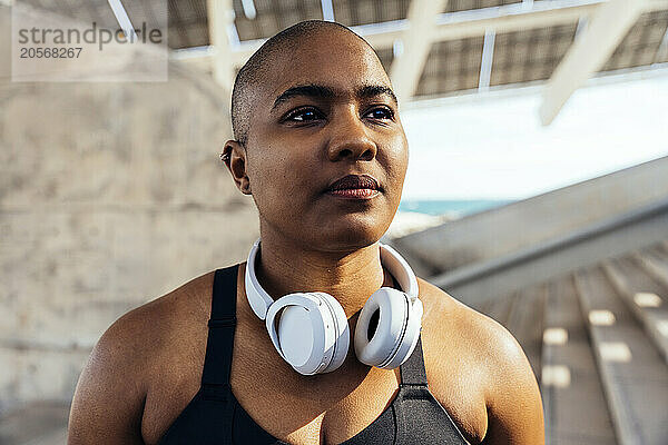 Confident sporty woman with headphones