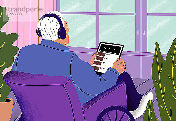 Elderly man in wheelchair enjoying online video at home