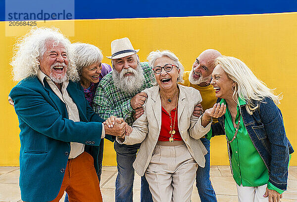 Playful elderly men and women enjoying leisure time together