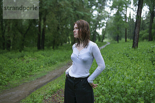 Young woman with wet hair posing in forest