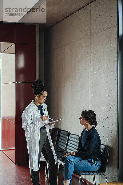 Healthcare worker discussing with patient in hospital