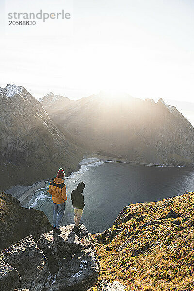 Friends standing on rocks at Lofoten and Nordic islands  Norway