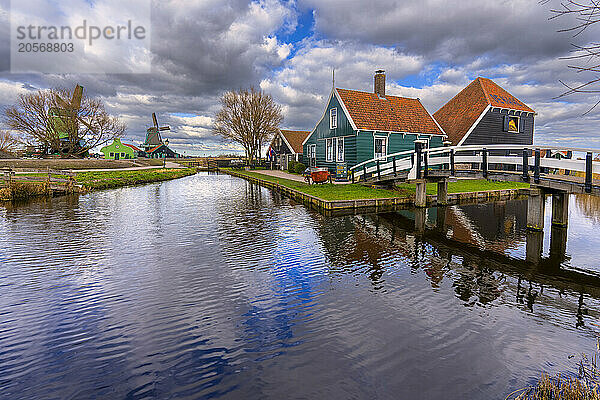 Zaanse Schans windmills near Amsterdam under cloudy sky in Netherlands